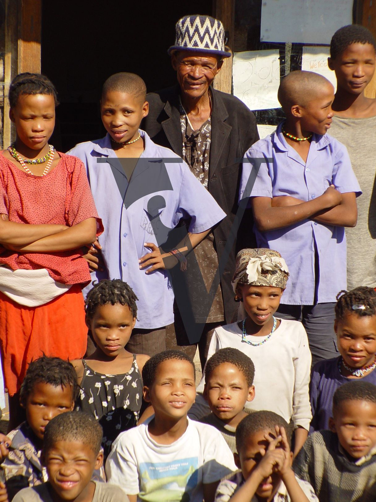 N!Xau, the “Bushman”, group image, smiling.