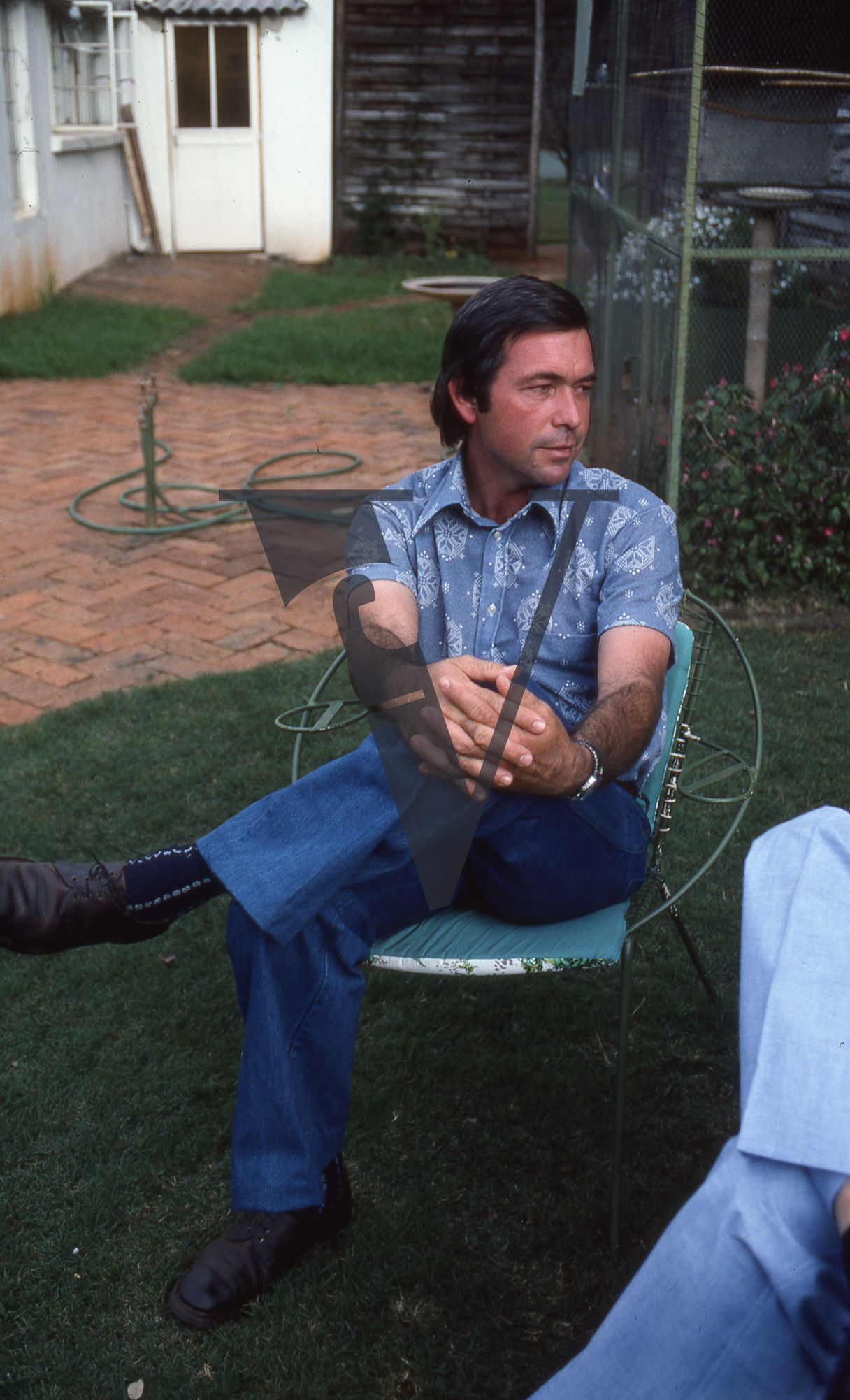 Rhodesia, Allan Savory, portrait, blue-shirt, legs crossed, interview.