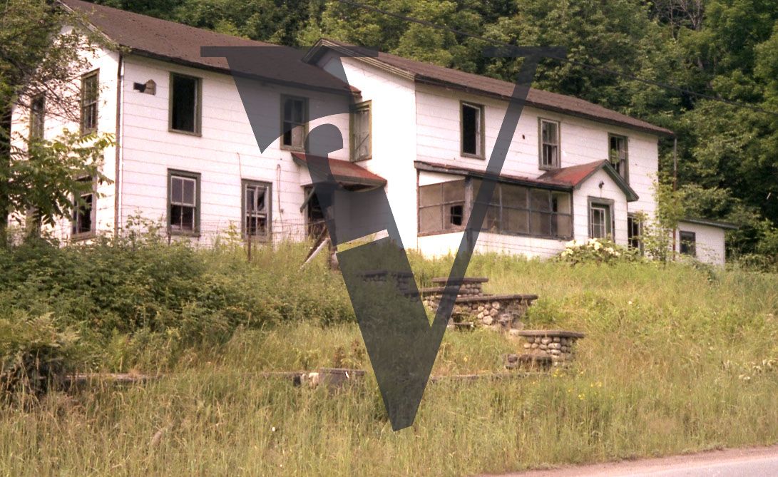 Abandoned hotel, exterior, wide shot.