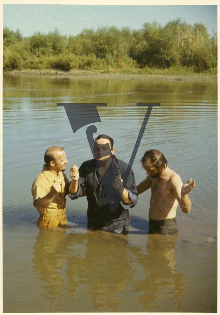 The Gospel Road, production stills, Johnny Cash in water, baptism.