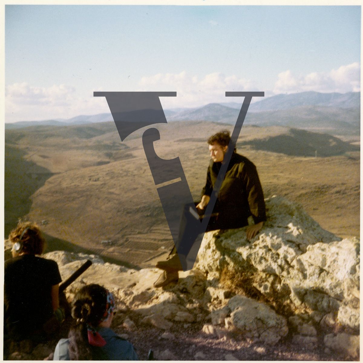 The Gospel Road, production stills, Johnny Cash on rock face, with Bible.