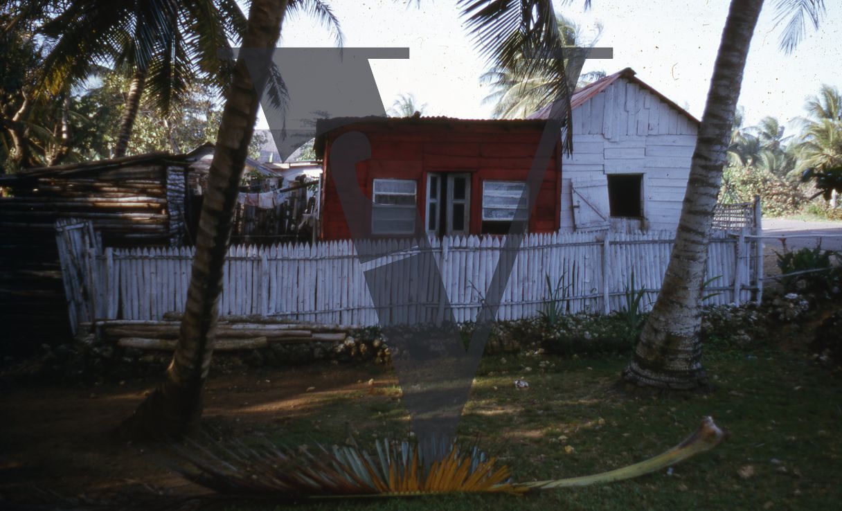 Jamaica, Beach huts under palm trees.